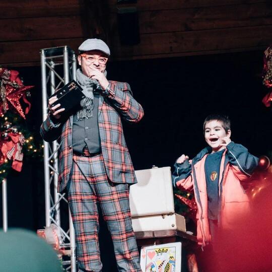 Wacko the Magician with a happy child on stage