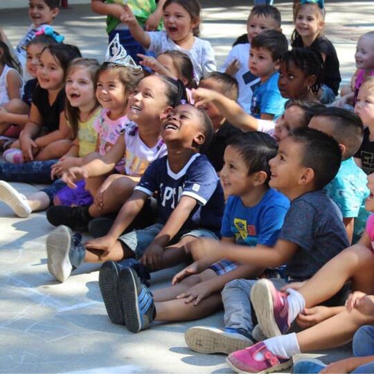 A group of diverse children smiling and laughing